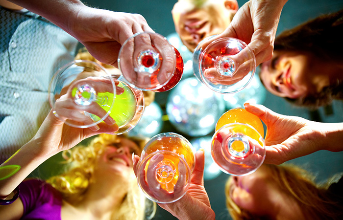Below view of people clinking glasses with each other